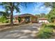 Home showcasing a detached garage, brick accents, solar panels, and well-kept landscaping at 435 Cody Dr, Lakewood, CO 80226