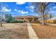 Charming single-story home with a well-manicured lawn, a walkway, and solar panels on the roof at 435 Cody Dr, Lakewood, CO 80226