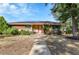 Single-story home with brick and siding exterior, solar panels, a walkway, and front porch seating at 435 Cody Dr, Lakewood, CO 80226