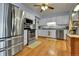 Kitchen featuring stainless steel appliances, white cabinets, and wood flooring at 435 Cody Dr, Lakewood, CO 80226