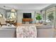 Sunlit living room showcasing hardwood floors, stylish furniture, and large windows with views of the front yard at 435 Cody Dr, Lakewood, CO 80226