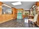 Spacious sunroom with tiled flooring, wood paneled walls, and pass-through to the kitchen at 435 Cody Dr, Lakewood, CO 80226