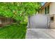 Grassy backyard features a portable garage and mature trees at 3525 S Brentwood St, Lakewood, CO 80235