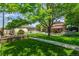 Spacious backyard with lush lawn, mature trees, garden, and shed at 3525 S Brentwood St, Lakewood, CO 80235