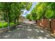 Long driveway with mature trees leading to the home and detached garage at 3525 S Brentwood St, Lakewood, CO 80235