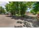 Spacious driveway with mature trees and view of garage and two-story home at 3525 S Brentwood St, Lakewood, CO 80235