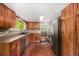 Well-lit kitchen boasting custom wood cabinets, stone backsplash, and modern stainless steel appliances at 3525 S Brentwood St, Lakewood, CO 80235