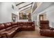 Cozy living room with high ceilings, a loft area, and a large brown leather sectional at 3525 S Brentwood St, Lakewood, CO 80235