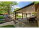 Inviting covered patio area with a beautiful water feature and outdoor seating at 3525 S Brentwood St, Lakewood, CO 80235