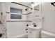 Bathroom with decorative tile, shower/tub combo, and modern fixtures at 7266 S Birch St, Centennial, CO 80122