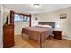 Bedroom featuring hardwood floors and a window with natural light at 7266 S Birch St, Centennial, CO 80122