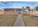 Inviting brick home featuring blue shutters, a bay window, and solar panels at 7266 S Birch St, Centennial, CO 80122