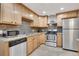 Modern kitchen features stainless steel appliances and granite countertops at 7266 S Birch St, Centennial, CO 80122
