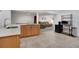 This kitchenette boasts light wood cabinets, modern appliances, and tile flooring, making entertaining guests a breeze at 7266 S Birch St, Centennial, CO 80122