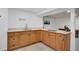 The kitchenette features light wood cabinets, modern appliances, and tile flooring, perfect for convenient food prep at 7266 S Birch St, Centennial, CO 80122
