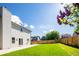 A spacious backyard featuring a large green lawn and wood fence that adds to the home's privacy at 13812 W 64Th Pl, Arvada, CO 80004