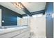 Bathroom features a double sink vanity, tile flooring, and a tiled shower at 13812 W 64Th Pl, Arvada, CO 80004