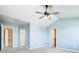 Bedroom with blue accent wall and plush carpet and neutral color scheme at 13812 W 64Th Pl, Arvada, CO 80004