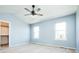 Bedroom features vaulted ceilings, a ceiling fan, neutral carpet, and large windows at 13812 W 64Th Pl, Arvada, CO 80004