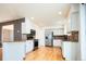 Bright kitchen boasts stainless steel appliances, stone countertops, and light wood floors at 13812 W 64Th Pl, Arvada, CO 80004