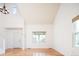 Spacious living room featuring hardwood floors, soaring ceilings, and an inviting atmosphere at 13812 W 64Th Pl, Arvada, CO 80004
