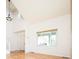 Bright living room with hardwood floors, high ceilings, and natural light from large windows at 13812 W 64Th Pl, Arvada, CO 80004