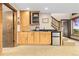 Bar area with wooden cabinets, a mini refrigerator and bar counter at 8456 N Sundown Trl, Parker, CO 80134