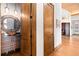 Elegant bathroom featuring custom sink, hardwood floors, and high end finishes at 8456 N Sundown Trl, Parker, CO 80134