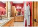Bathroom with wooden cabinets, double sinks, and a walk-in shower at 8456 N Sundown Trl, Parker, CO 80134