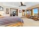 Bedroom with a ceiling fan, carpet, and stone exterior wall visible through windows at 8456 N Sundown Trl, Parker, CO 80134