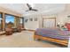 Bedroom featuring a ceiling fan, exterior stone, and views of the outdoors at 8456 N Sundown Trl, Parker, CO 80134
