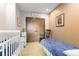Charming bedroom with a crib, twin bed, rocking chair, and wood closet doors at 8456 N Sundown Trl, Parker, CO 80134
