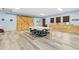 Bright bonus room boasts blue walls, wood floors, barn doors, and windows with custom wood trim at 8456 N Sundown Trl, Parker, CO 80134