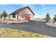 Exterior shot of a garage featuring stone walls and a red garage door at 8456 N Sundown Trl, Parker, CO 80134