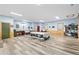 Large flex space featuring lots of natural light, wood paneling, and painted blue walls at 8456 N Sundown Trl, Parker, CO 80134