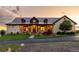 Charming home featuring stone facade, metal roof, well-manicured lawn, and welcoming front porch at 8456 N Sundown Trl, Parker, CO 80134