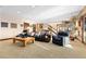 Spacious living room with a dark sofa, a ceiling with recessed lights and carpet flooring at 8456 N Sundown Trl, Parker, CO 80134
