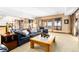 Spacious living room with a dark sofa, a ceiling with recessed lights, and sliding doors at 8456 N Sundown Trl, Parker, CO 80134