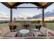 Relax on this spacious patio with cozy seating and a table to enjoy the scenic sunset views at 8456 N Sundown Trl, Parker, CO 80134