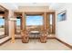 Sitting area featuring views of the outdoors, unique floor lamp, and stone details at 8456 N Sundown Trl, Parker, CO 80134