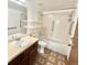 Bathroom featuring a tub/shower combo, grab bars, and vanity at 13992 E Marina Dr # 303, Aurora, CO 80014