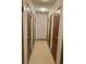Hallway featuring multiple doors with gold handles and neutral flooring at 13992 E Marina Dr # 303, Aurora, CO 80014