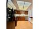 Kitchen with a black refrigerator, stainless steel stove, wood cabinets, and a unique ceiling light at 13992 E Marina Dr # 303, Aurora, CO 80014