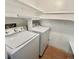 Laundry room with washer and dryer, wood-colored flooring, and white shelving at 13992 E Marina Dr # 303, Aurora, CO 80014