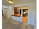 View of kitchen from carpeted living room featuring a breakfast bar and stainless steel appliances at 13992 E Marina Dr # 303, Aurora, CO 80014