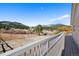Relaxing back deck showcasing stunning views of the valley and mountain landscape at 87 Elmgreen Ln, Evergreen, CO 80439