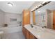Bathroom featuring soaking tub, vanity with cabinets, and neutral walls at 87 Elmgreen Ln, Evergreen, CO 80439