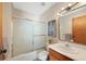 Bathroom featuring shower-tub combo with sliding glass door at 87 Elmgreen Ln, Evergreen, CO 80439