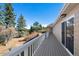 Long deck with white railings offering beautiful views of the surrounding landscape at 87 Elmgreen Ln, Evergreen, CO 80439