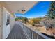 Spacious deck with a scenic view of the mountains and surrounding trees at 87 Elmgreen Ln, Evergreen, CO 80439